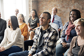 image of people sitting in a group and smiling