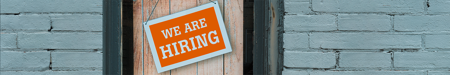 image of a We are Hiring Sign on the wood door